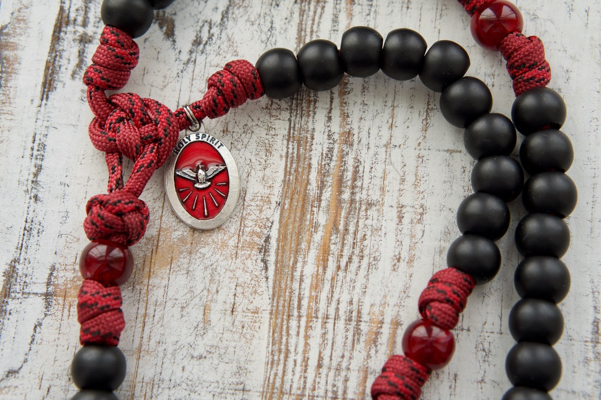 The Crimson Shield - Holy Spirit Confirmation Paracord Rosary: Durable 550 paracord rosary with large maroon beads and black Hail Mary beads, featuring a red enamel Holy Spirit medal and black St. Benedict crucifix for spiritual protection and battle readiness.