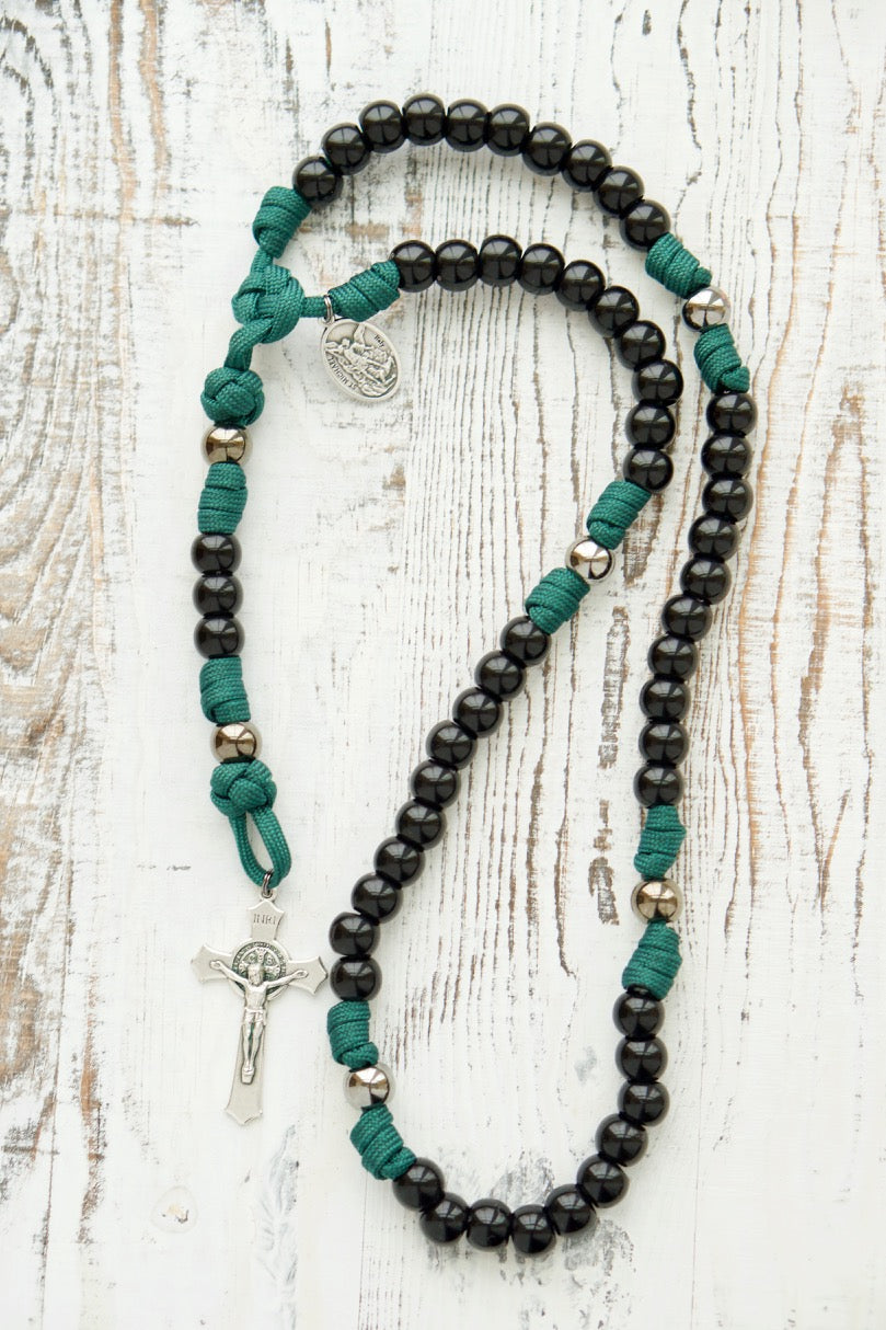 Dark Night of the Soul - 5 Decade Paracord Rosary, featuring a durable and unbreakable dark green paracord rope, black and gunmetal beads, St. Michael and Guardian Angel devotional medal, St. Benedict Crucifix, and perfect for young Catholics seeking spiritual strength and protection in challenging times.