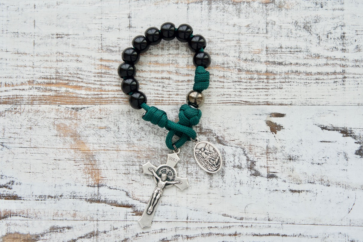 Dark Night of the Soul - 1 Decade Paracord Rosary, featuring durable gunmetal & black beads, St. Michael and Guardian Angel medals, and a compact St. Benedict Crucifix for on-the-go prayer. Tested and guaranteed unbreakable for spiritual strength and protection.
