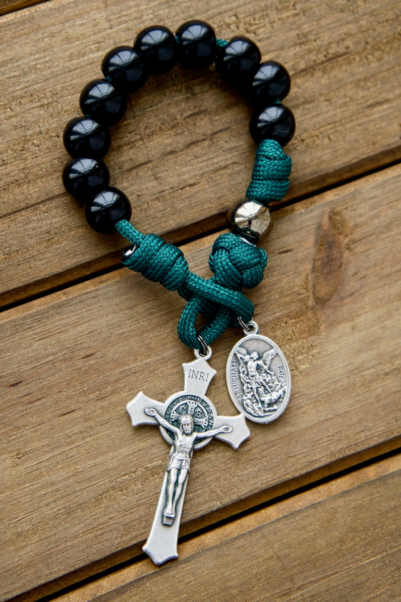Dark Night of the Soul - 1 Decade Paracord Rosary, featuring a compact design with durable green paracord, black and gunmetal beads, St. Michael and Guardian Angel medal, St. Benedict Crucifix, perfect for carrying prayer with you on-the-go, and guaranteed not to break in any life's battles!