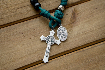 Dark Night of the Soul - 1 Decade Paracord Rosary (alt text): A durable, compact, and stylish paracord rosary for prayer on-the-go, featuring St. Michael, Guardian Angel, and St. Benedict Crucifix medals in dark green rope with black and gunmetal accents.