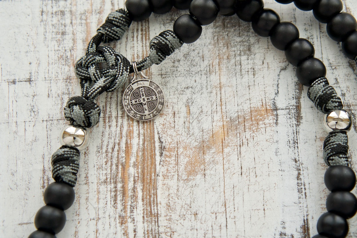 The Demon Destroyer - Black and Silver 5 Decade Paracord Rosary, handmade by a small Catholic family of 6, featuring a durable paracord design, silver pardon crucifix, St. Benedict medal, and ideal for men's spiritual protection in daily life.