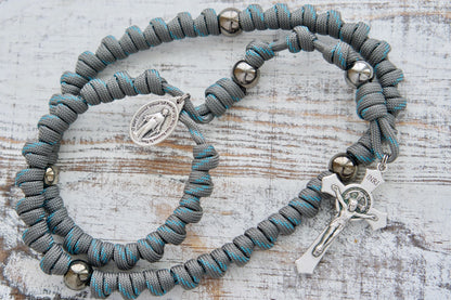Embrace the spiritual strength of the Heaven's Embrace - Grey, Teal Blue, Gunmetal Knotted Rope Rosary. This full-size paracord rosary is designed to protect you in any spiritual battle with its sturdy Paracord 550 rope and grey & gunmetal design. 