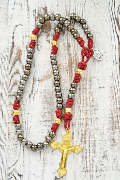 The Holy Family 5 Decade Paracord Rosary - Durable, premium unbreakable paracord rosary for strong Catholic faith, featuring royal red, gold, and gunmetal design with a 3" gold crucifix and Holy Family/St. Joseph medal. Perfect spiritual weapon for prayer on the go.