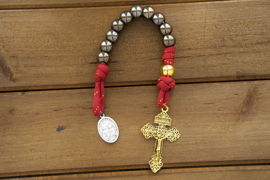 The Holy Family - 1 Decade Paracord Rosary with royal red, gold, and gunmetal design, featuring an antique gold Pardon crucifix and a double-sided Holy Family/St. Joseph medal. Durable, premium paracord rosary for prayer and protection on life's battles.