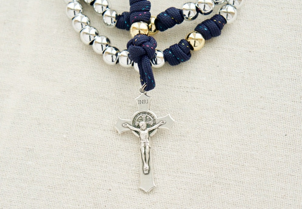 Premium navy blue paracord rosary with silver Hail Mary beads, gold Our Father beads, St. Benedict Crucifix, and Miraculous Medal; perfect for prayer and spiritual strength. Handmade by a Catholic family of 6.