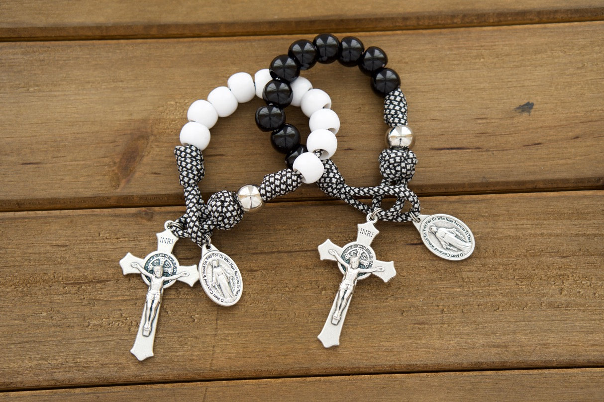 Two single decade pocket Paracord Rosaries in black and white alternating colors with St. Benedict crucifixes, Miraculous Medals, and perfect for a Catholic wedding gift.