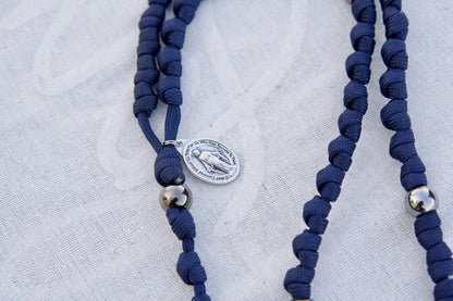 Navy Blue and Gunmetal Knotted Rope Rosary with Miraculous Medal and St. Benedict Crucifix, durable paracord design for prayer and spiritual protection on-the-go, measuring 19 inches in length, perfect for kids and adults alike.