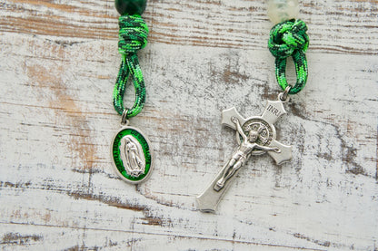 Our Lady of Guadalupe - 1 Decade Paracord Rosary, featuring green Hail Mary beads and white Our Father beads, durable for daily use and inspired by the calming presence of Our Lady. Includes devotional medal and St. Benedict Crucifix. Perfect for carrying or holding during prayer, with a unique one-of-a-kind design to enhance your spiritual life.