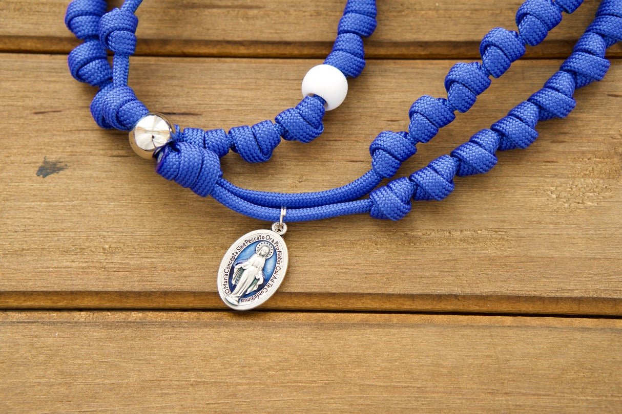 Embrace divine protection with our Miraculous Blue Knotted Rope Rosary, featuring a St. Benedict crucifix and a blue enamel Miraculous medal. This durable Paracord 550 rope rosary is perfect for on-the-go prayers and has been battle-tested by kids to ensure unbreakable strength. A must-have Catholic gift for every faithful warrior!