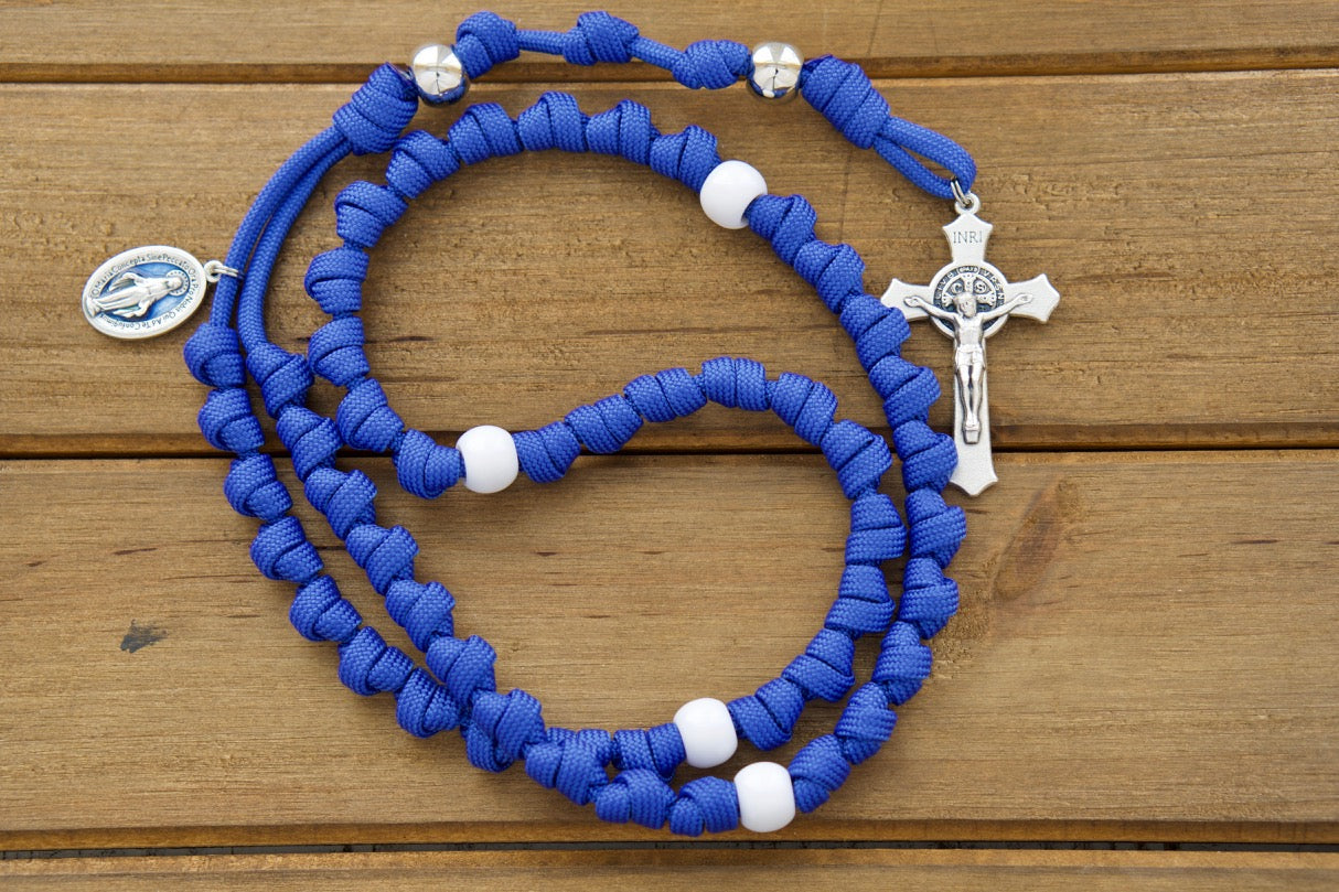 Embrace the divine protection of Our Lady with our Miraculous Blue Knotted Rope Rosary, a premium unbreakable paracord rosanary that combines spiritual strength and durability for Catholic warriors on-the-go. Featuring a 2" St. Benedict crucifix, blue enamel 1" Miraculous medal, silver & white acrylic beads, this rosary is the ultimate Catholic gift to carry Mary's grace in every battle.