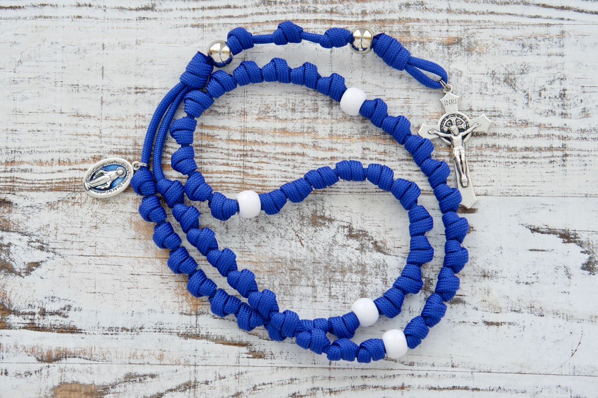 Our Lady of the Miraculous Medal - Knotted Rope Rosary in vibrant blue, featuring a 2" St. Benedict crucifix, blue enamel 1" Miraculous medal, and silver & white acrylic beads. Durable Paracord 550 rope construction ensures strength for life's battles. The perfect Catholic gift for on-the-go prayer warriors.