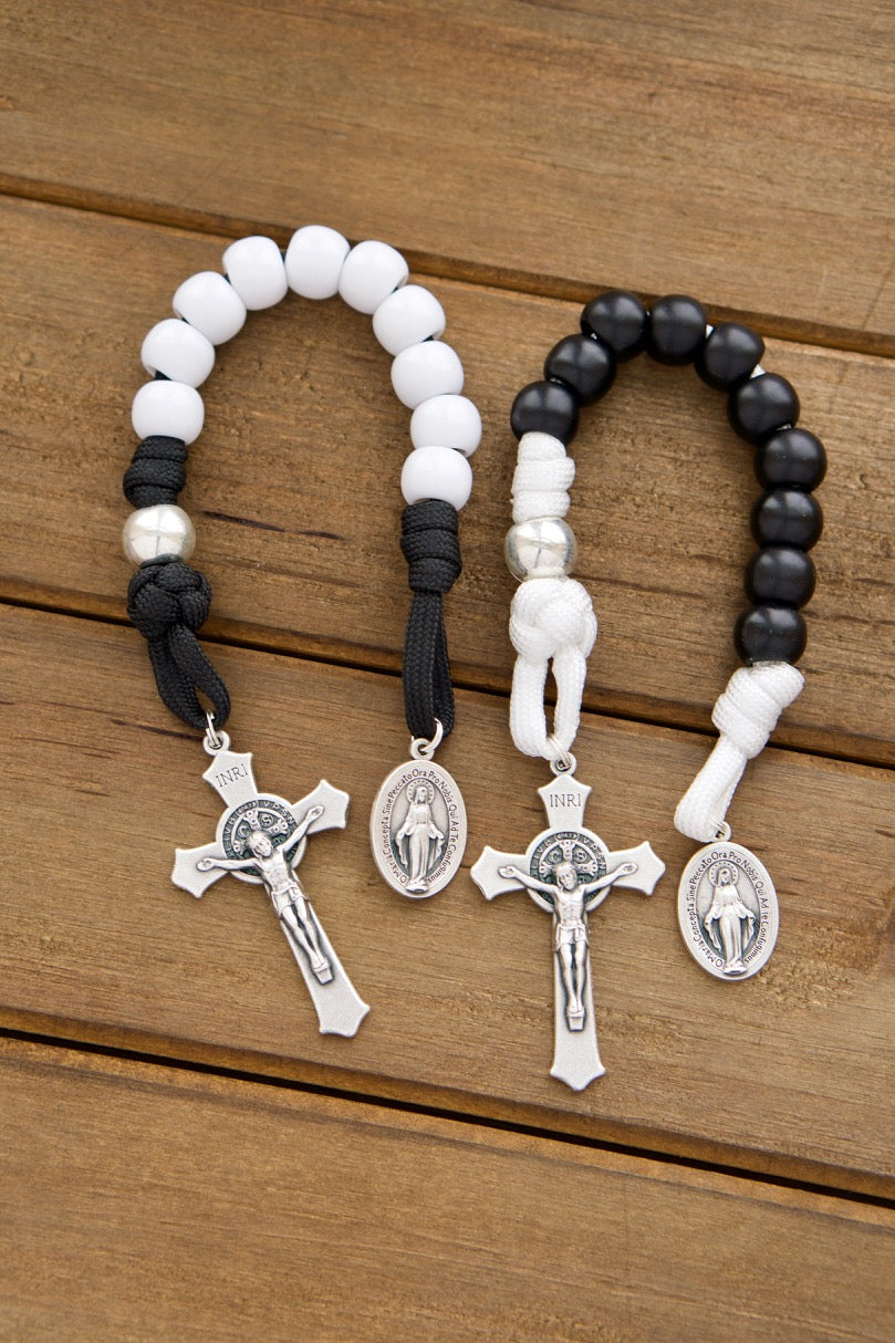 Rosary Pair: Bride & Groom 1 Decade Rosary - A perfect Catholic wedding or anniversary gift for the newlyweds or veteran couples, featuring a bridge and groom white and black design. This durable paracord rosary includes a St. Benedict Crucifix and Miraculous Medal Devotional. Handmade by our small Catholic family, it's an unbreakable Catholic gift for your loved ones.