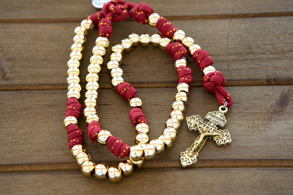 Scarlet Crown - Royal Red and Gold Paracord Rosary with 10mm Gold Beads, Subtle Gold Ribbon in Red Paracord, Gold Hail Mary and Our Father Beads, 2" Gold Pardon Crucifix, and Miraculous Medal for Devout Catholics.