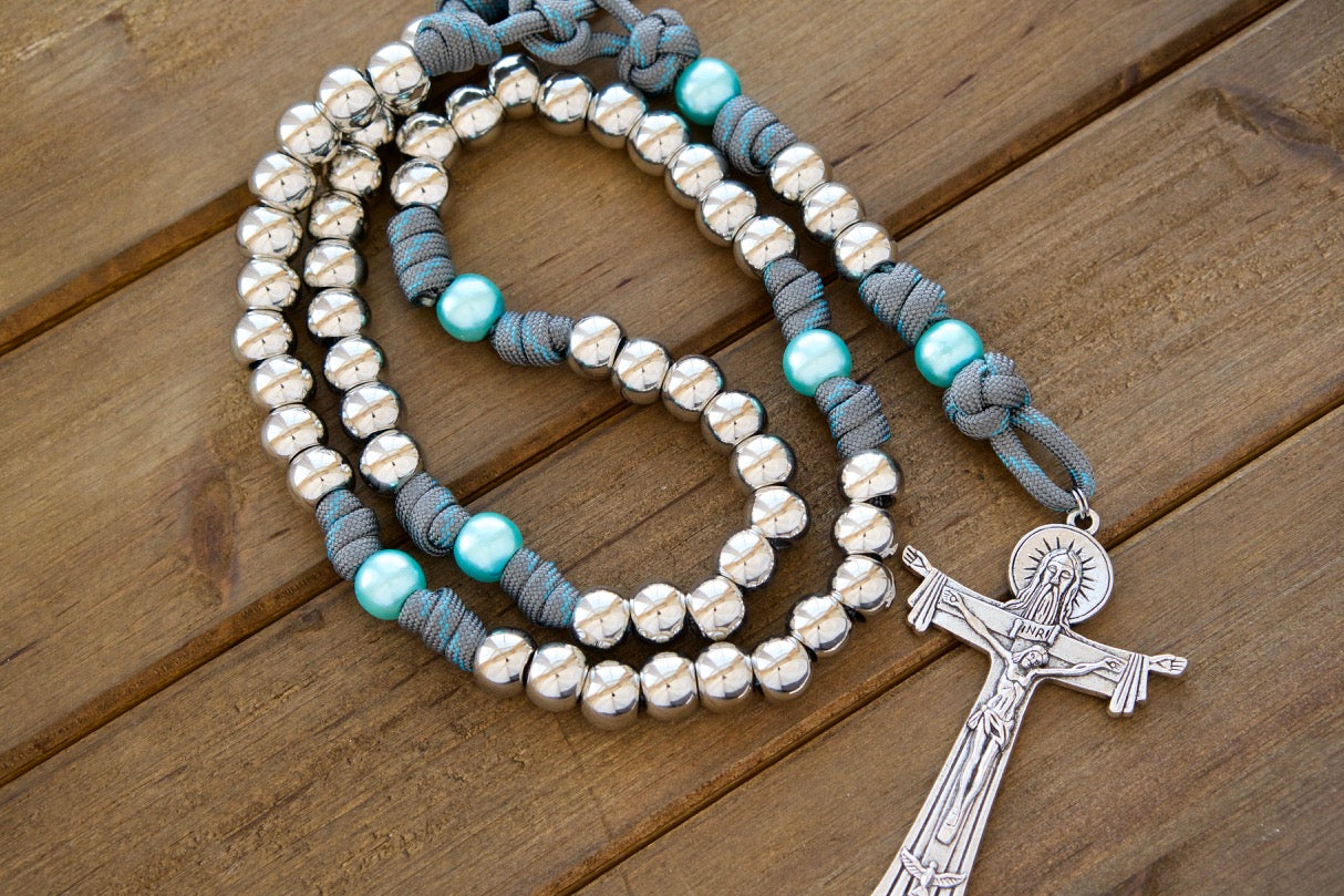 St. Anne's Intercession - Sky Blue, Gray and Silver - 5 Decade Paracord Rosary: Durable paracord rosary with silver Hail Mary beads, sky blue Our Father beads, St. Anne medal, and Holy Trinity Crucifix. Handmade by a Catholic family of 6 for spiritual strength and devotion.