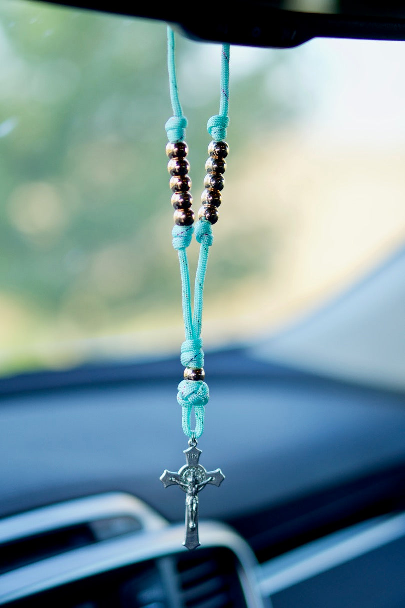 Teal and Rose Gold Rearview Mirror Paracord Rosary - A stunning Catholic gift, perfect for any woman's car. Handmade by our Catholic family of 6 with durable paracord rope, rose gold beads, and a St. Benedict Crucifix. Expandable to 13" for versatility. 
