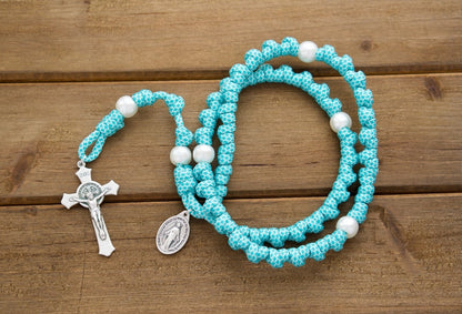 The Peaceful Waters - Teal Blue and White Knotted Rope Rosary with white pearl Our Father beads, St. Benedict Crucifix, and Miraculous Medal. Durable 19-inch Paracord 550 rosary for spiritual battles. Handmade by Sanctus Servo's Catholic family of 6.