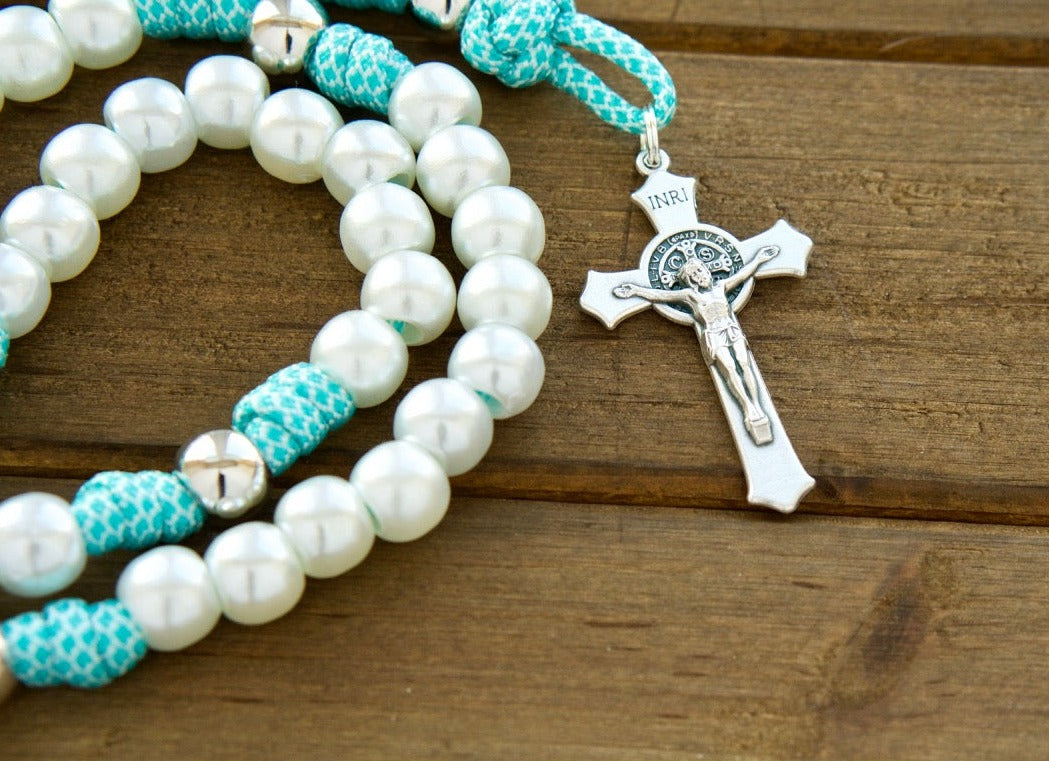 Sanctus Servo Peaceful Waters - White, Silver, and Teal Blue - 5 Decade Rosary, featuring durable paracord 550 rope, pearl Hail Mary beads, silver Our Father beads, a standard size 2" St. Benedict Crucifix, and a devotional Miraculous Medal for modern Catholic women to elevate their prayer life.