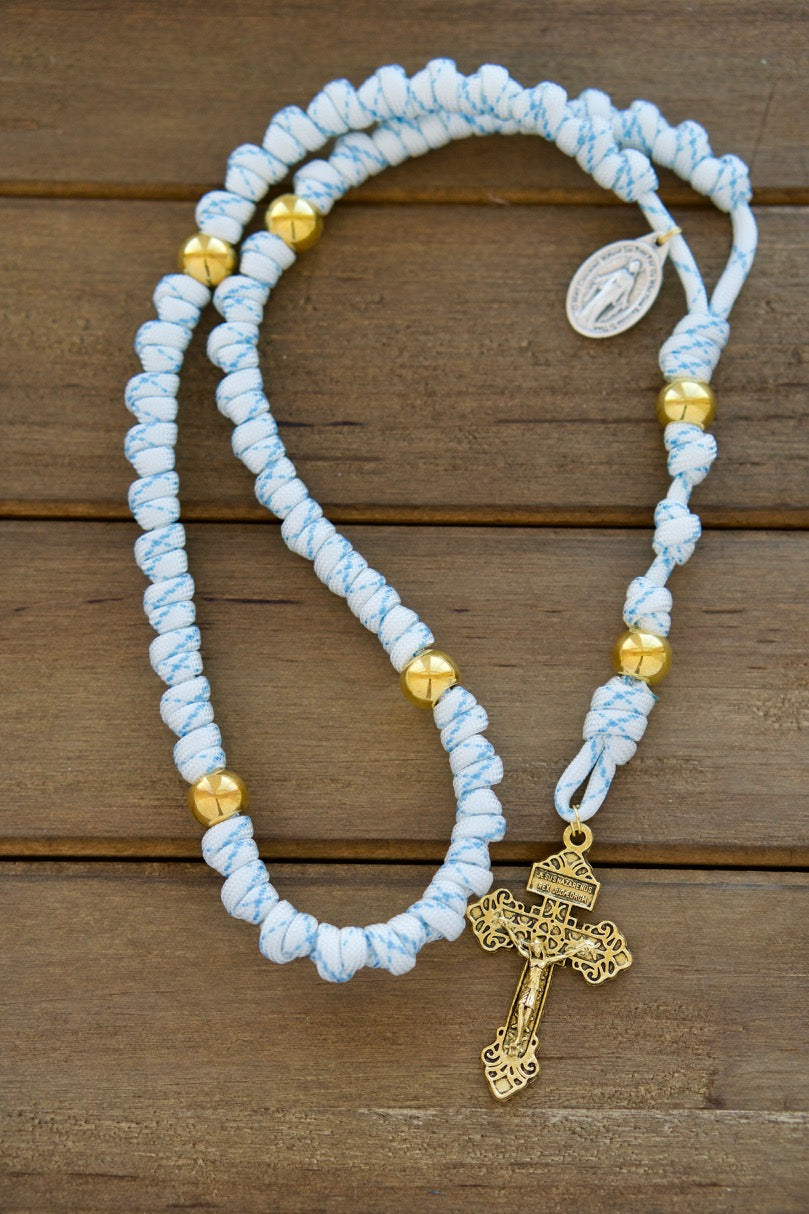 Unshakable Faith - White, Blue and Gold Rope Rosary by Sanctus Servo: Empower yourself in the spiritual battle with this durable premium paracord rosary featuring white and blue design, gold Our Father beads, a standard size 2" Gold Pardon Crucifix, and a devotional Miraculous Medal. This unbreakable paracord rosary is perfect for Catholic gifts and ensures the strength of your faith journey with its full-size length of 19 inches and pocket or purse-friendly design.