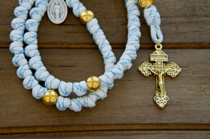 Unleash the power of unshakable faith with Sanctus Servo's premium white, blue, and gold rope rosary - a durable, Catholic gift for your spiritual battles! 👑🌐✨